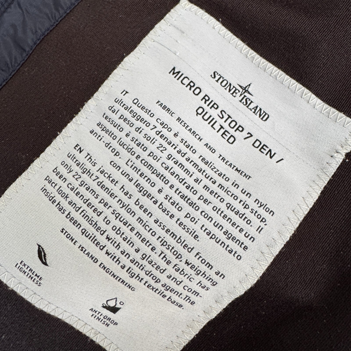 Stone Island navy quilted jacket with logo patch and micro rip stop material.