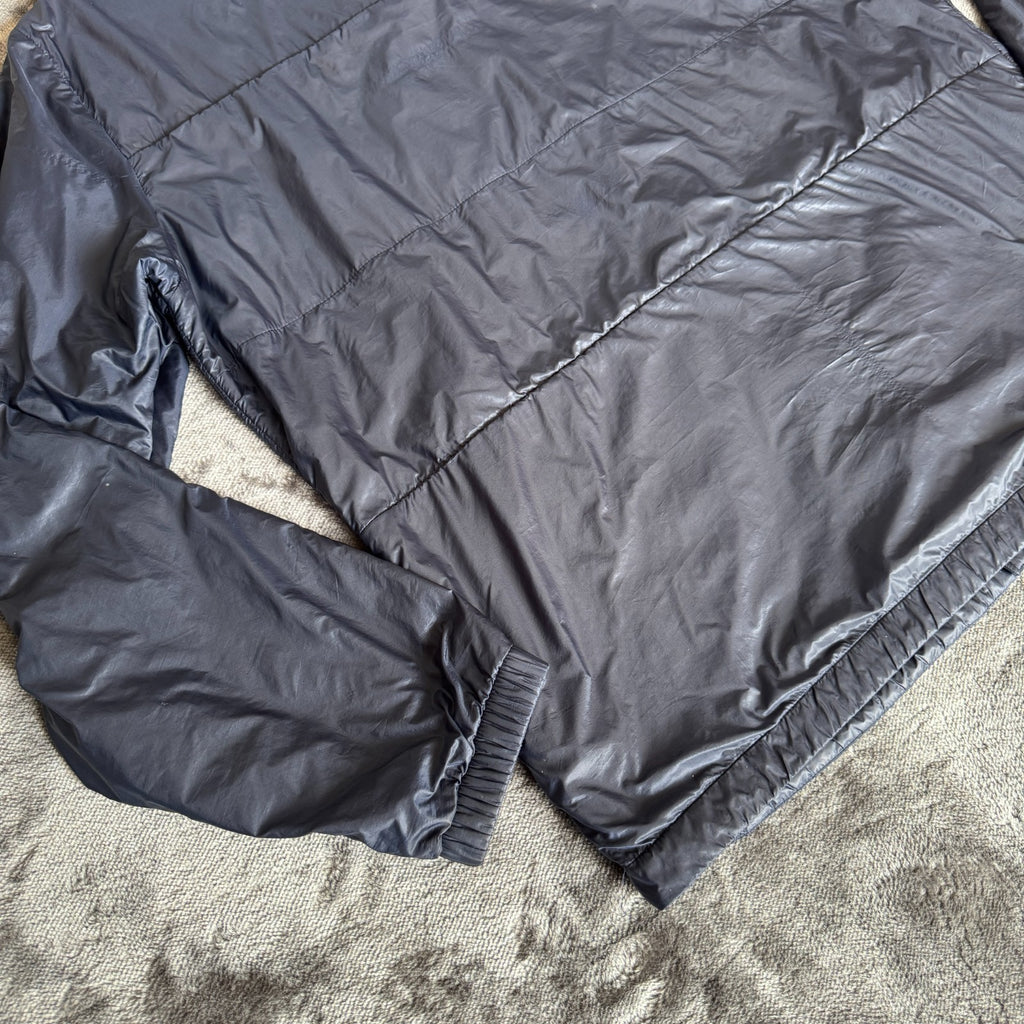 Stone Island navy quilted jacket with logo patch and micro rip stop material.