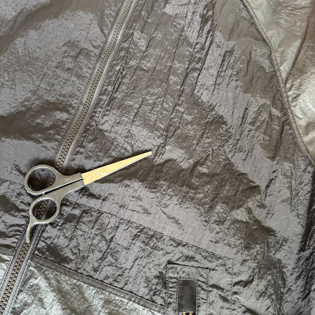 Stone Island black nylon metal Watro jacket with logo badge and visible wear marks.