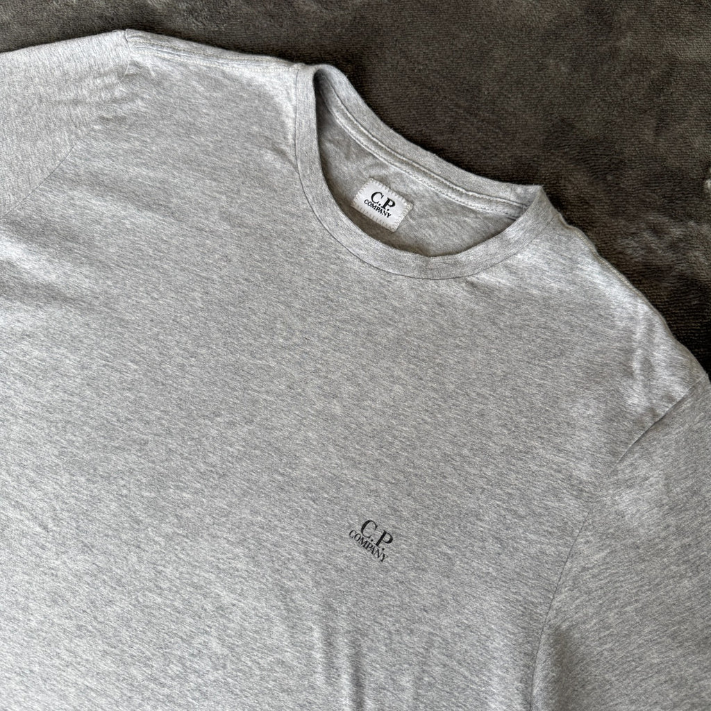 C.P. Company grey t-shirt featuring distinctive goggle print and logo detail.