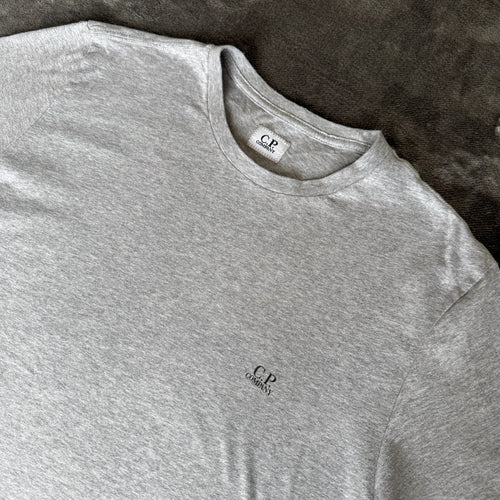 C.P. Company grey t-shirt featuring distinctive goggle print and logo detail.