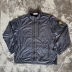 Stone Island navy quilted jacket with logo patch and micro rip stop material.