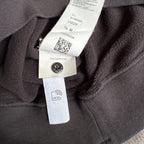 Stone Island black crewneck sweatshirt with zipped pocket and iconic compass logo.