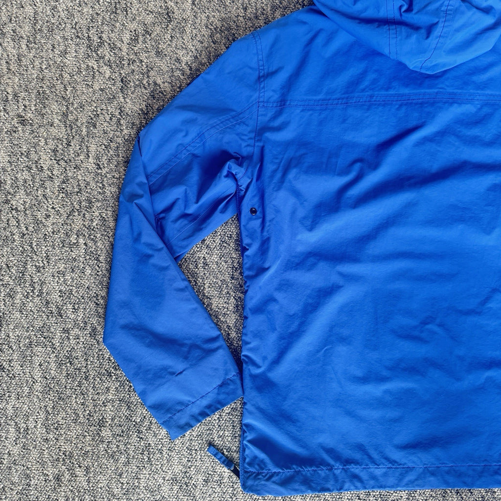 Napapijri blue anorak jacket with logo chest flap and quarter-zip front closure.