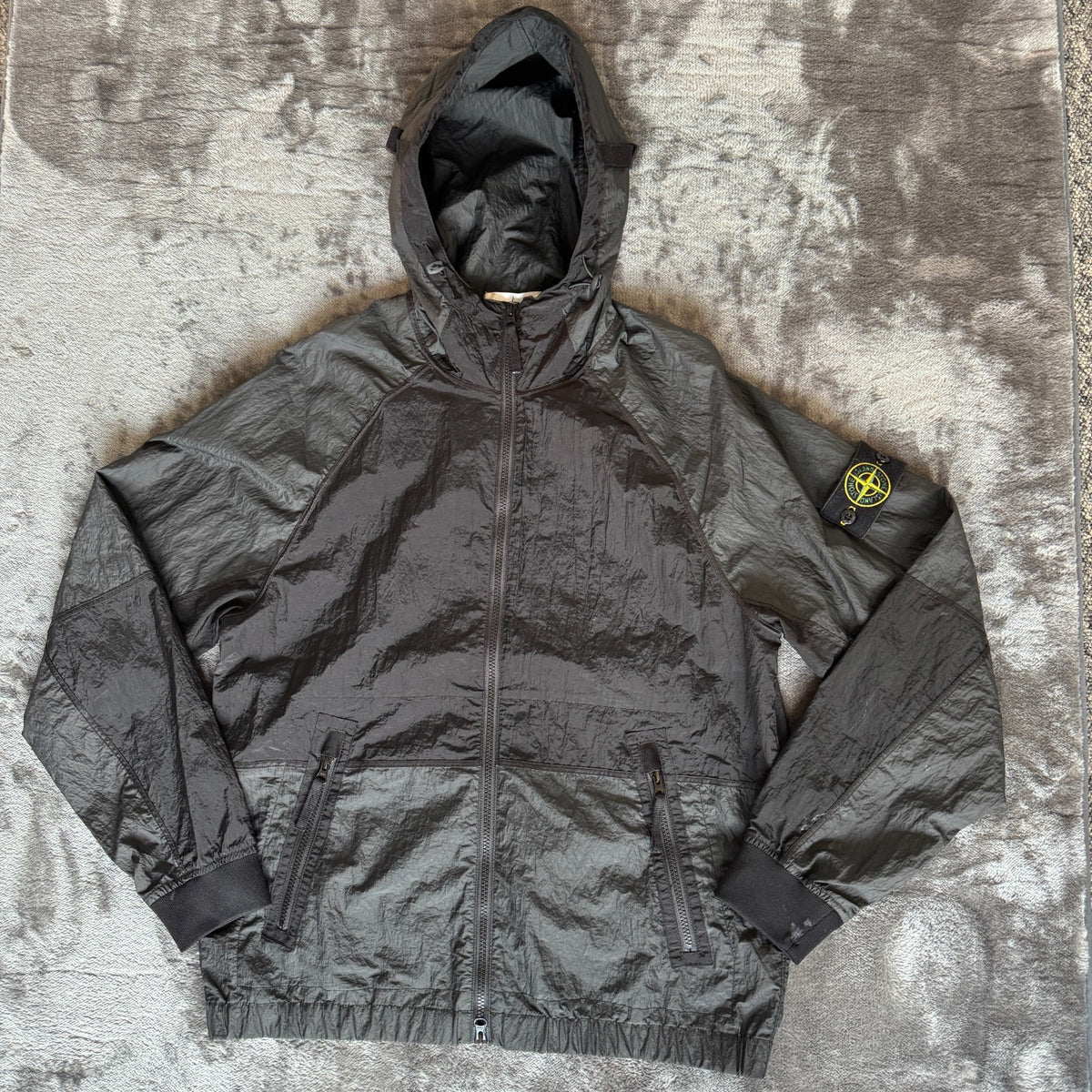 Stone Island black nylon metal Watro jacket with logo badge and visible wear marks.