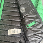 Stone Island green down jacket with logo patch and 0-cotton/R-nylon material.