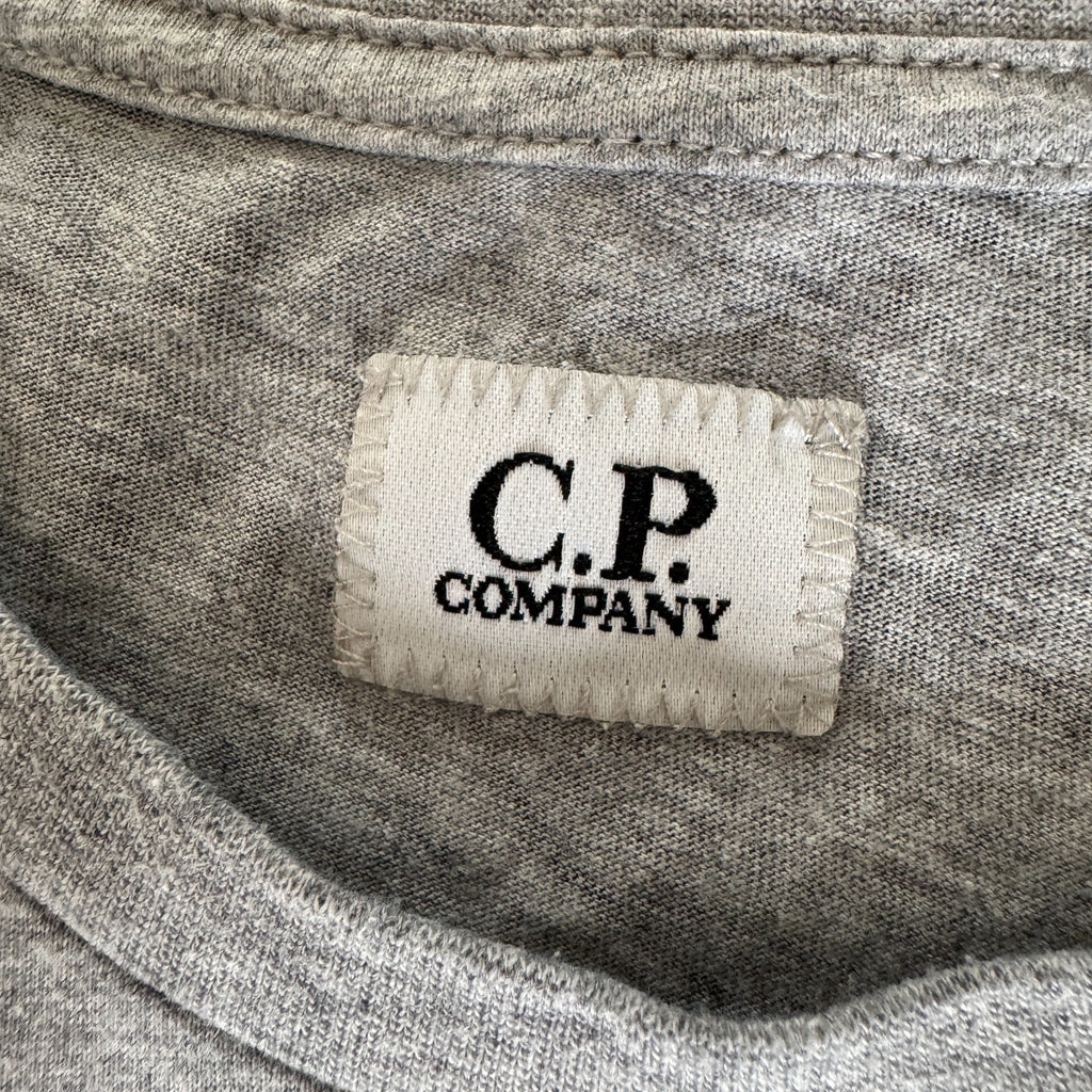 C.P. Company grey t-shirt featuring distinctive goggle print and logo detail.
