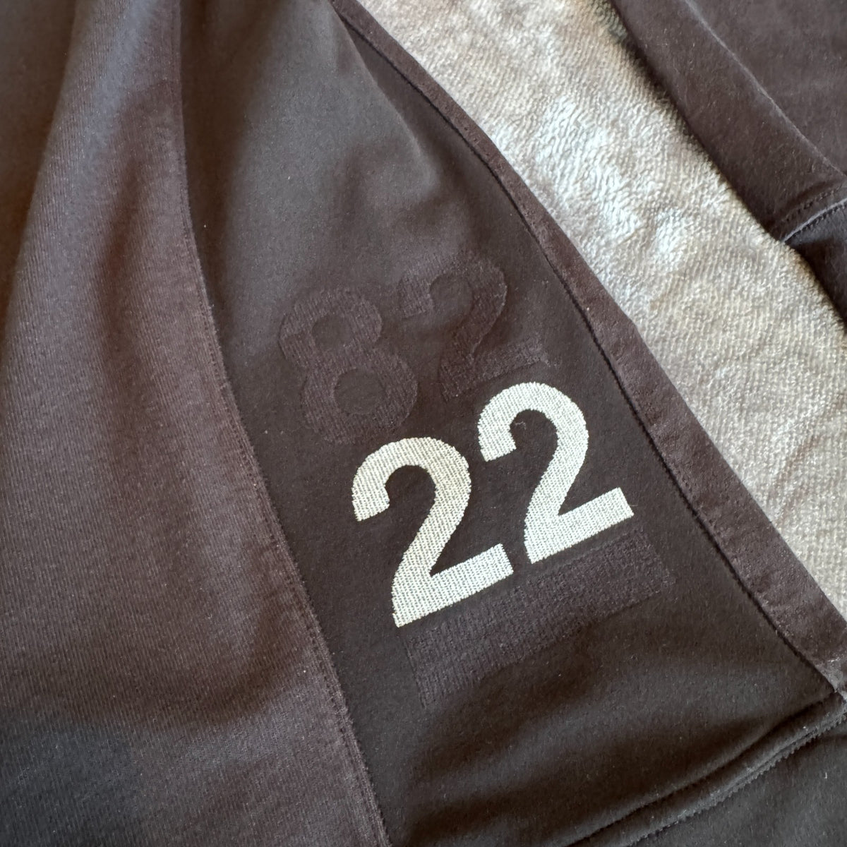 Stone Island black crewneck sweatshirt with 40th anniversary badge and logo patch.