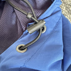 Napapijri blue anorak jacket with logo chest flap and quarter-zip front closure.
