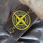 Stone Island navy quilted jacket with logo patch and micro rip stop material.