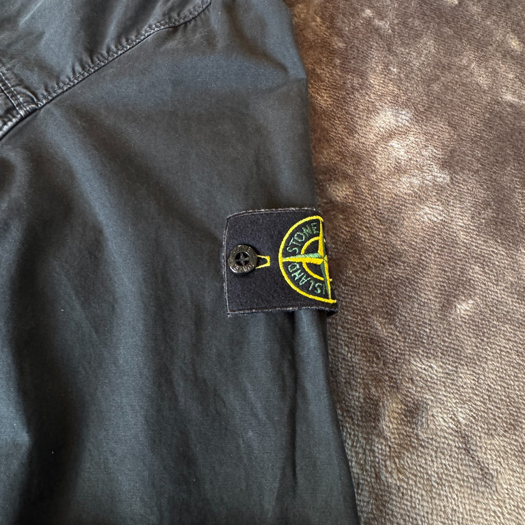 Stone Island black overshirt with logo patch and button-up front detail.