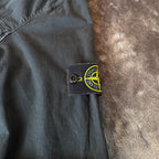 Stone Island black overshirt with logo patch and button-up front detail.