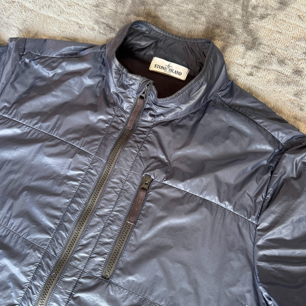 Stone Island navy quilted jacket with logo patch and micro rip stop material.