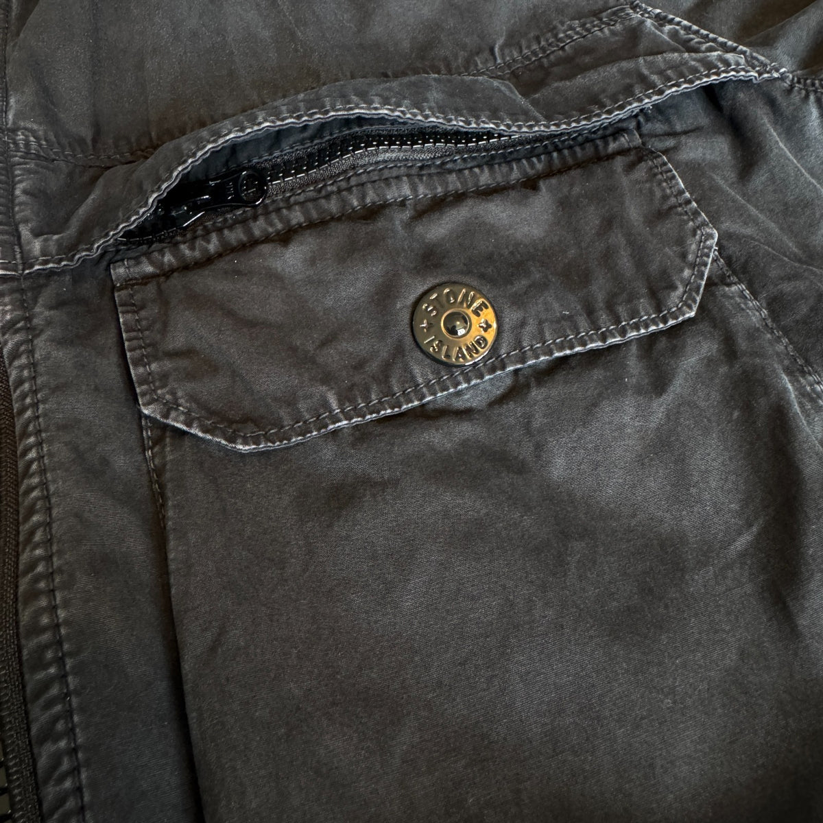 Stone Island black overshirt with logo patch and button-up front detail.