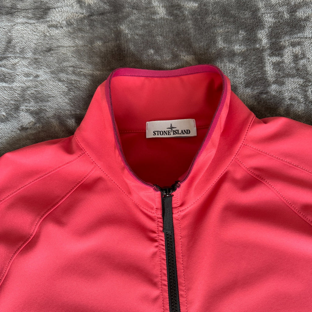 Stone Island fuchsia track jacket with logo badge and stretch nylon material.