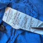 C.P. Company blue windbreaker jacket with big lens detail and garment-dyed finish.