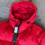 Stone Island red puffer jacket with compass patch, adjustable hood, and multiple pockets.