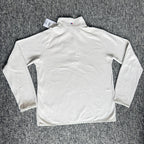 Berghaus off-white half-zip fleece with black logo pocket and stand-up collar.