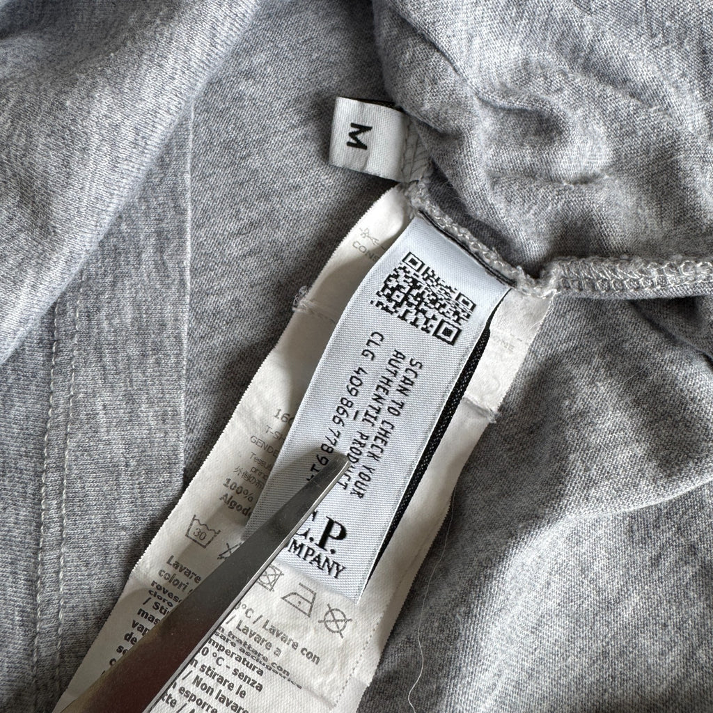 C.P. Company grey t-shirt featuring distinctive goggle print and logo detail.