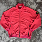 Stone Island fuchsia track jacket with logo badge and stretch nylon material.