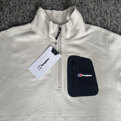 Berghaus off-white half-zip fleece with black logo pocket and stand-up collar.