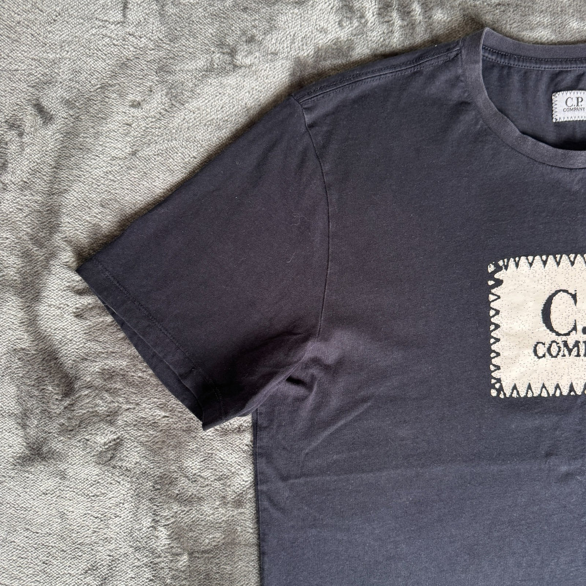 C.P. Company navy t-shirt with stamped logo and soft cotton material.