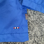 Napapijri blue anorak jacket with logo chest flap and quarter-zip front closure.